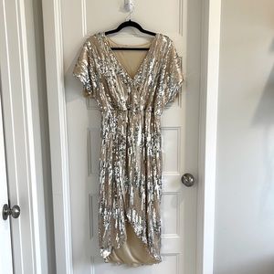 Gold sequin dress. Slit in front for elegance